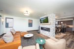 The pass through fireplace connects the modern living room & dining area.